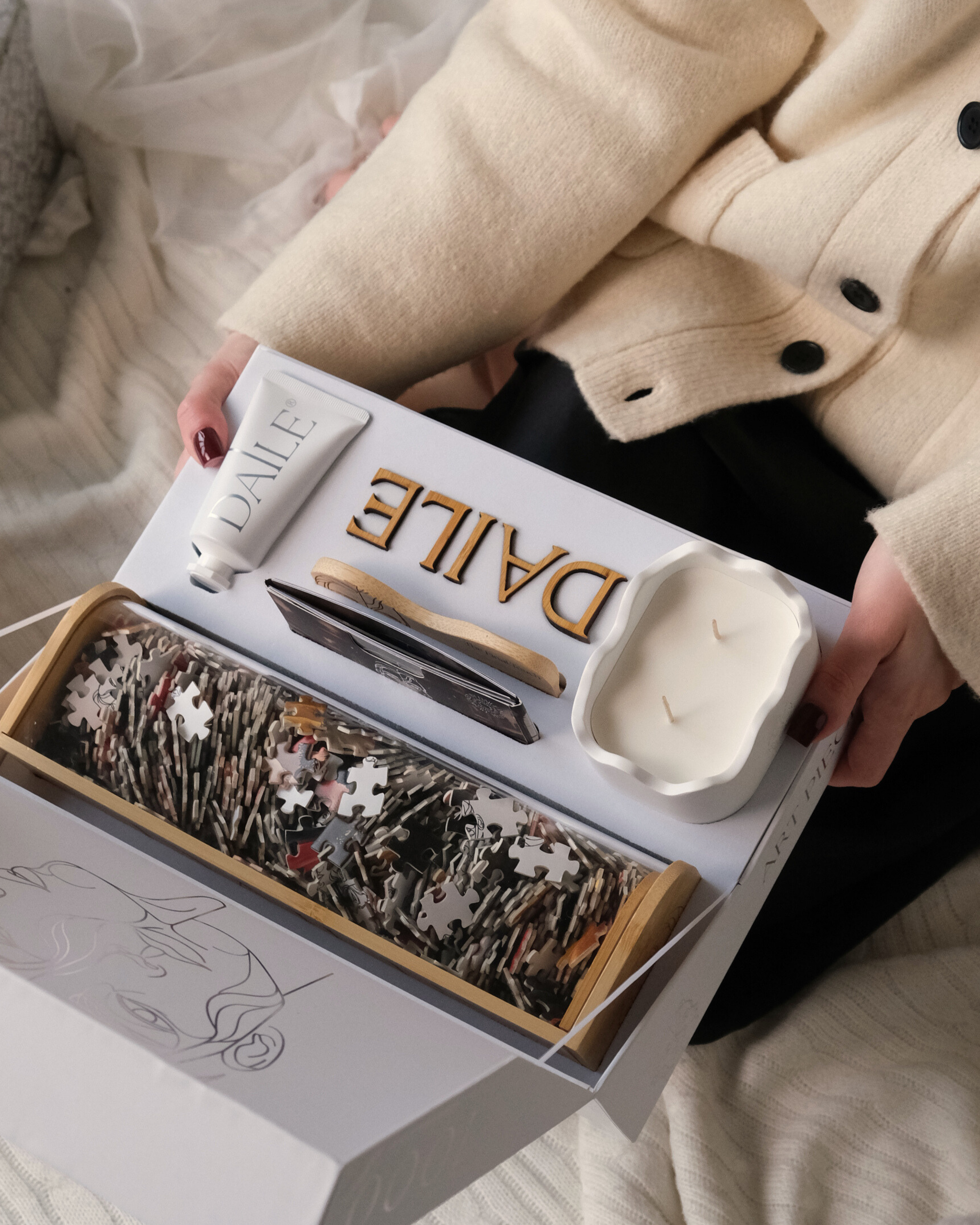 Luxury art puzzle gift set with puzzle pieces, candle, and accessories in a box