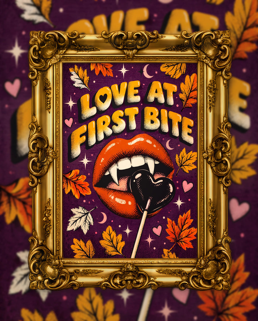 Love at First Bite, an original DAILE Studio Halloween artwork in an ornate gold frame — retro poster of glossy red lips with vampire fangs biting a dark heart lollipop, under orange bubble lettering reading Love at First Bite, on plum.