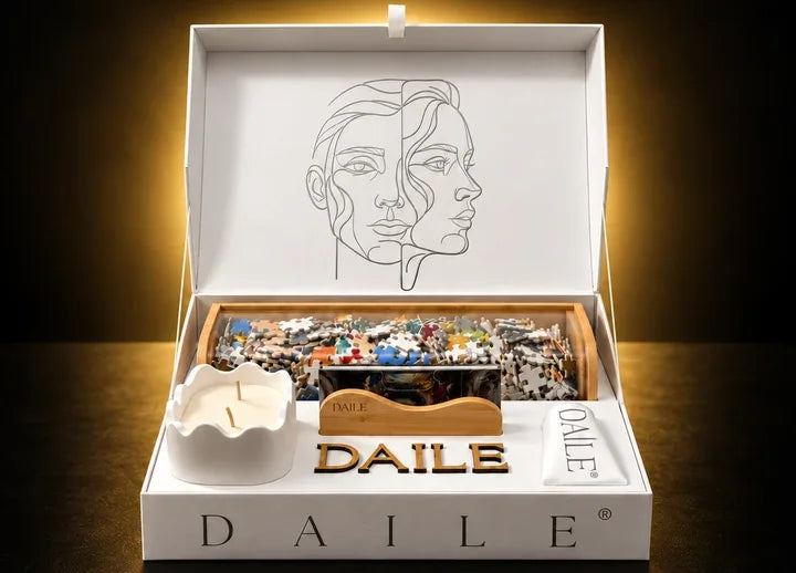 An open DAILE Signature gift box: puzzle pieces in a bamboo capsule, a candle and a display stand.