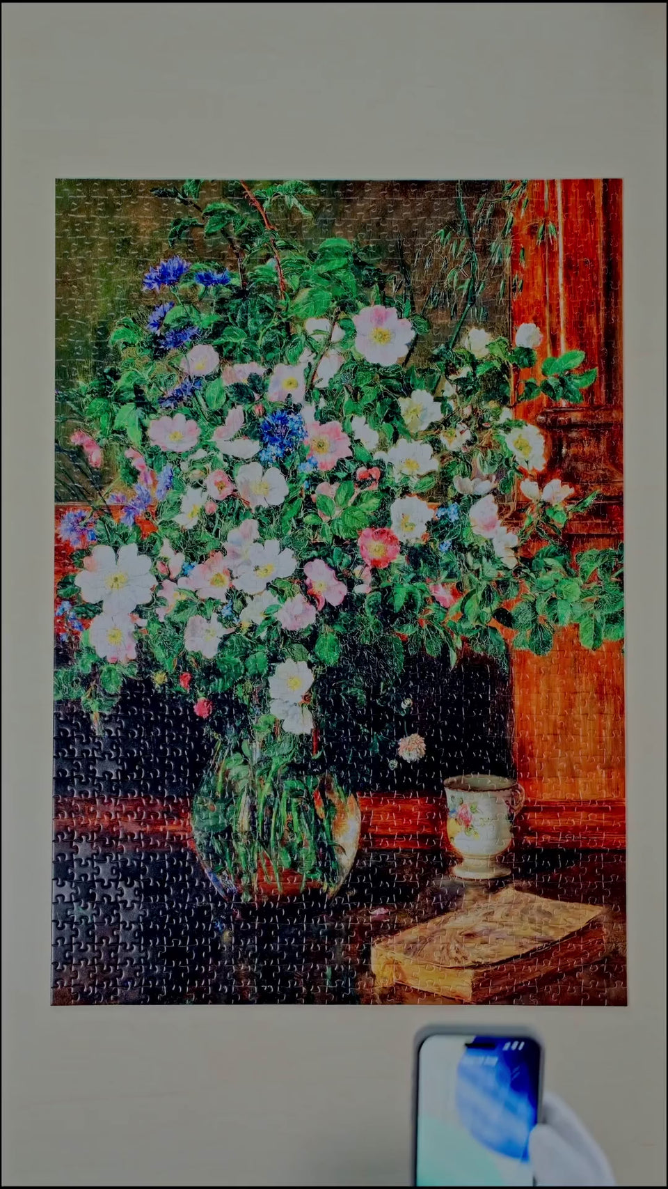 A phone held to the corner of a finished DAILE puzzle.